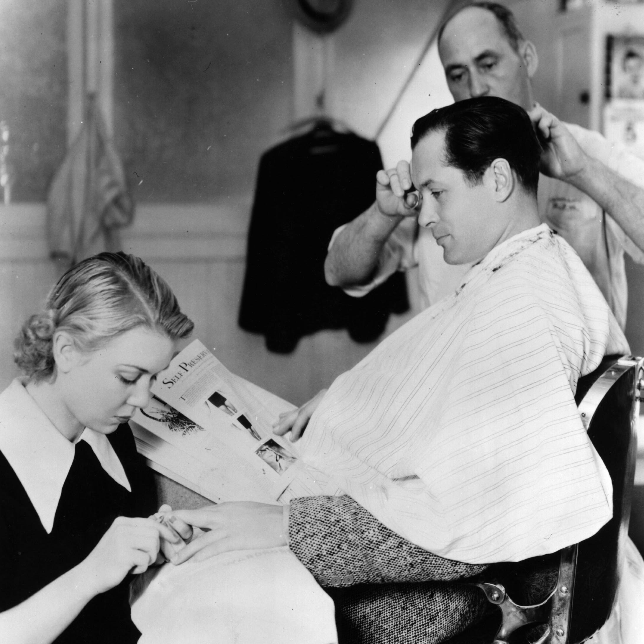 circa 1933: Robert Montgomery, the Hollywood star, signed by MGM, seen having a trim and manicure in the studio barber shop. (Photo by Hulton Archive/Getty Images)