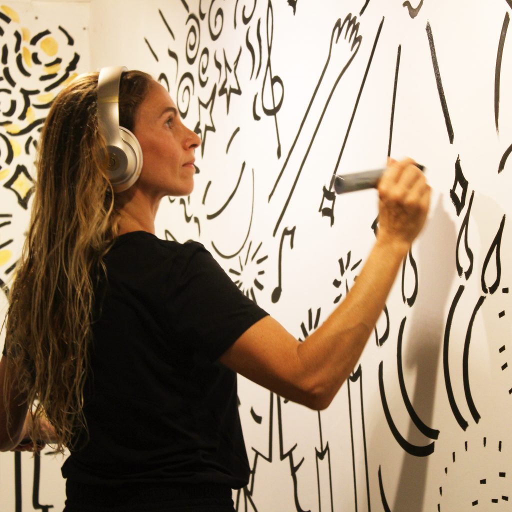Bibiana Domit pintando sus murales