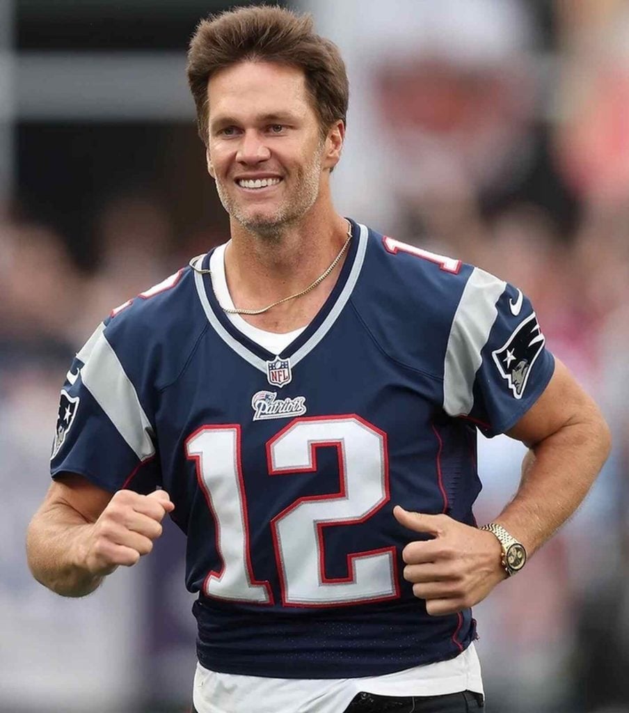 Tom Brady corriendo con un Rolex que subasta