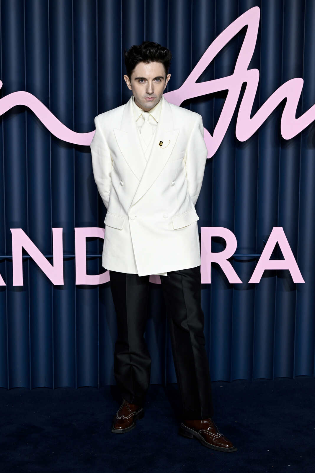 Daniel Fletcher posando en la alfombra roja de los British Fashion Awards