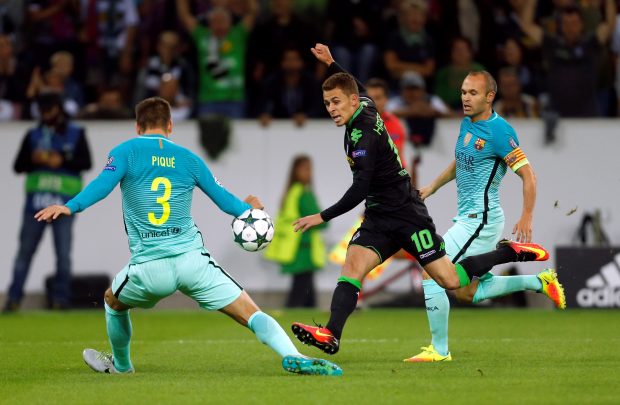 MOENCHENGLADBACH, GERMANY - SEPTEMBER 28 : Thorgan Hazard of Moenchengladbach challenges with Gerard Pique (L) and Andres Iniesta (R) of Barcelona during the UEFA Champions League group C soccer match between Borussia Moenchengladbach and FC Barcelona at the Borussia Park stadium in Moenchengladbach, Germany on September 28, 2016. (Photo by Ina Fassbender/Anadolu Agency/Getty Images)