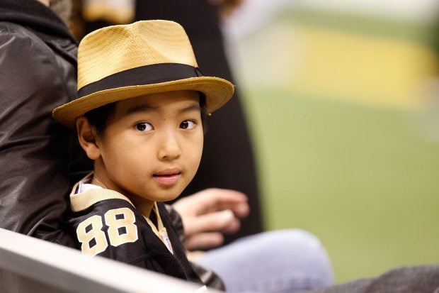 NEW ORLEANS - JANUARY 16: Maddox Jolie-Pitt sits on the bench on the sidelines during warm ups prior to the New Orleans Saints hosting the Arizona Cardinals during the NFC Divisional Playoff Game at Louisana Superdome on January 16, 2010 in New Orleans, Louisiana. (Photo by Ronald Martinez/Getty Images)