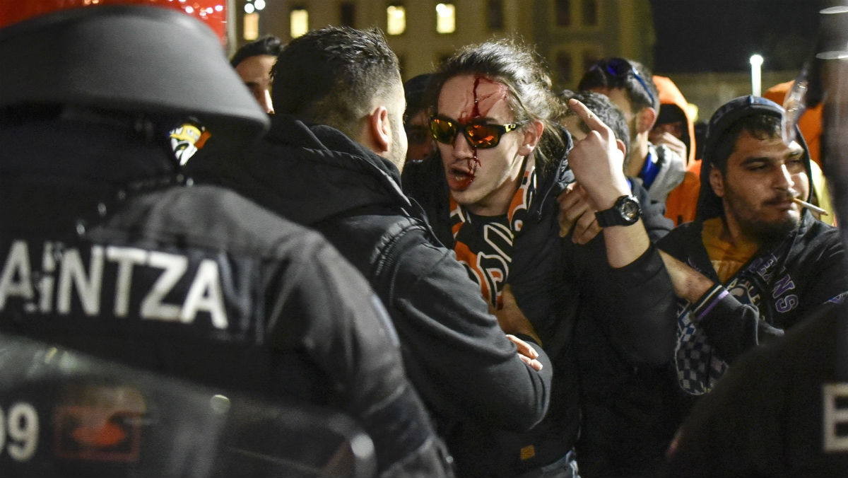 Seguidores del Apoel de Nicosia ante agentes de la Ertzaintza en las inmediaciones del estadio de San Mamés. (EFE)