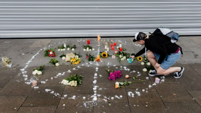 Una mujer deposita una vela en el lugar donde el atacante de Hamburgo acuchilló a una mujer hasta matarla. Foto: AFP