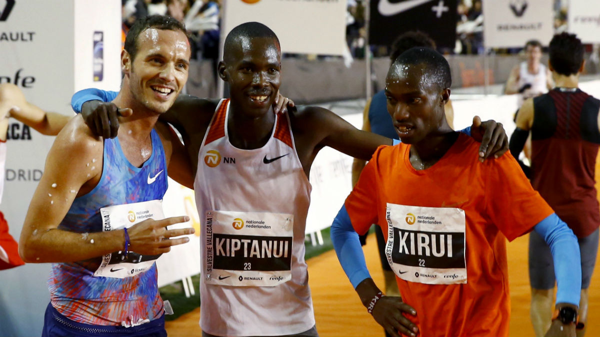 El keniano Eric Kiptanui posa junto a su compatriota Amos Kirui y al español Toni Abadía tras lograr la primera, segunda y tercera posición, en la San Silvestre Vallecana. (EFE)