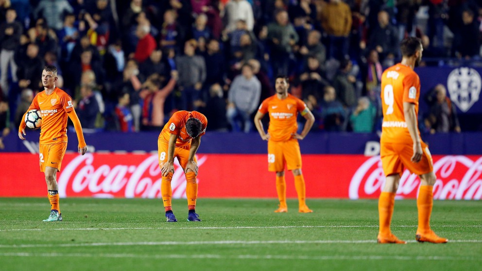 Los jugadores del Málaga se lamentan tras el gol que confirmó el descenso a segunda. (EFE)