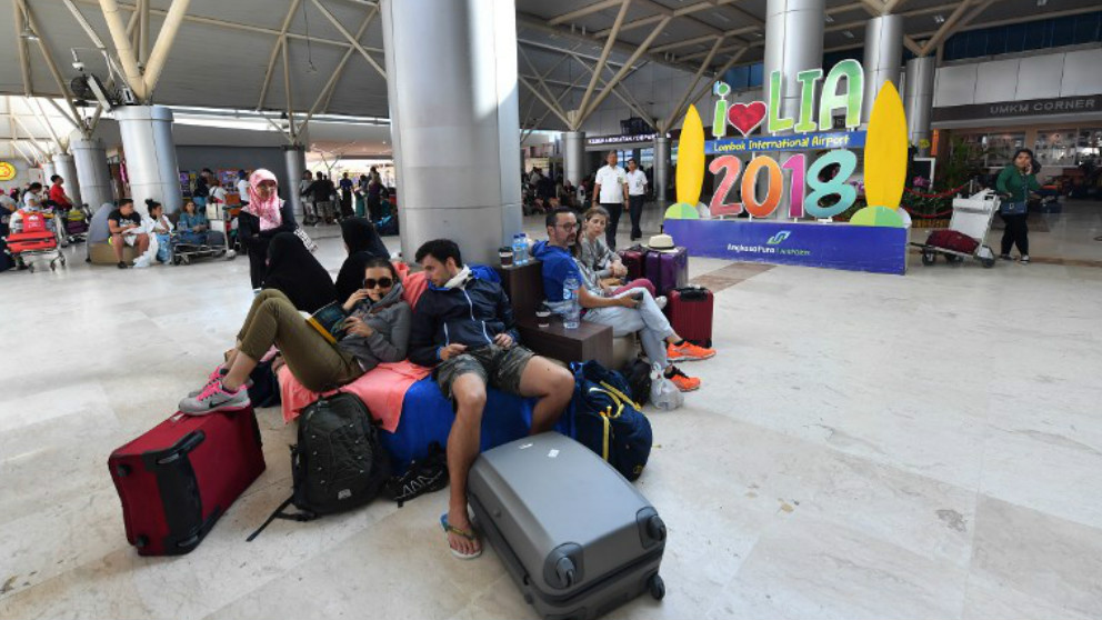 Un grupo de turistas esperan en el aeropuerto de Praya Lambok a poder salir de Indonesia tras el terremoto. Foto: AFP