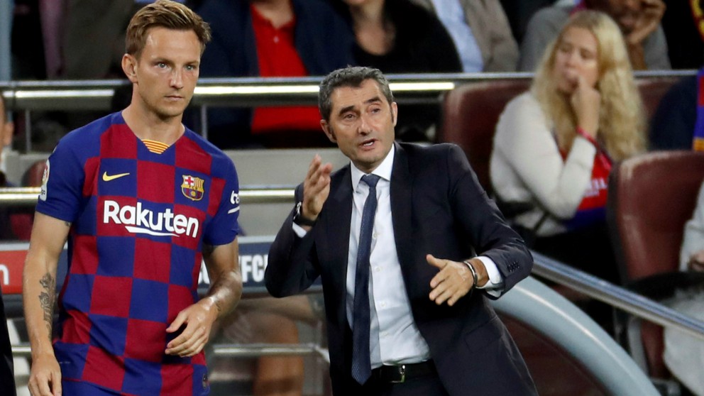 Rakitic, con gesto serio, recibe instrucciones de Valverde. (AFP)