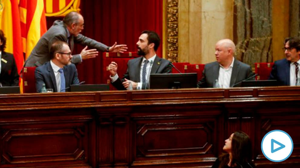 La diputada de la CUP en el Parlament de Cataluña, Maria Sirvent (abajo), interviene este martes ante el pleno, mientras el presidente de la cámara catalana, Roger Torrent (c), discute con el letrado mayor, Joan Ridao (2i). La sesión plenaria del Parlament vota una moción de la CUP que habla de autodeterminación, un texto cuya admisión a trámite ha recurrido el Gobierno central ante el TC, que ya ha advertido en varias ocasiones de las posibles consecuencias penales en casos de este tipo. EFE/Quique García