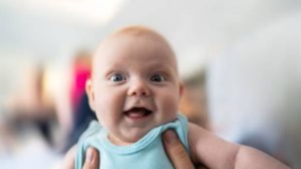 La foto de arriba de un sonriente 9 meses Baby Boy , que está