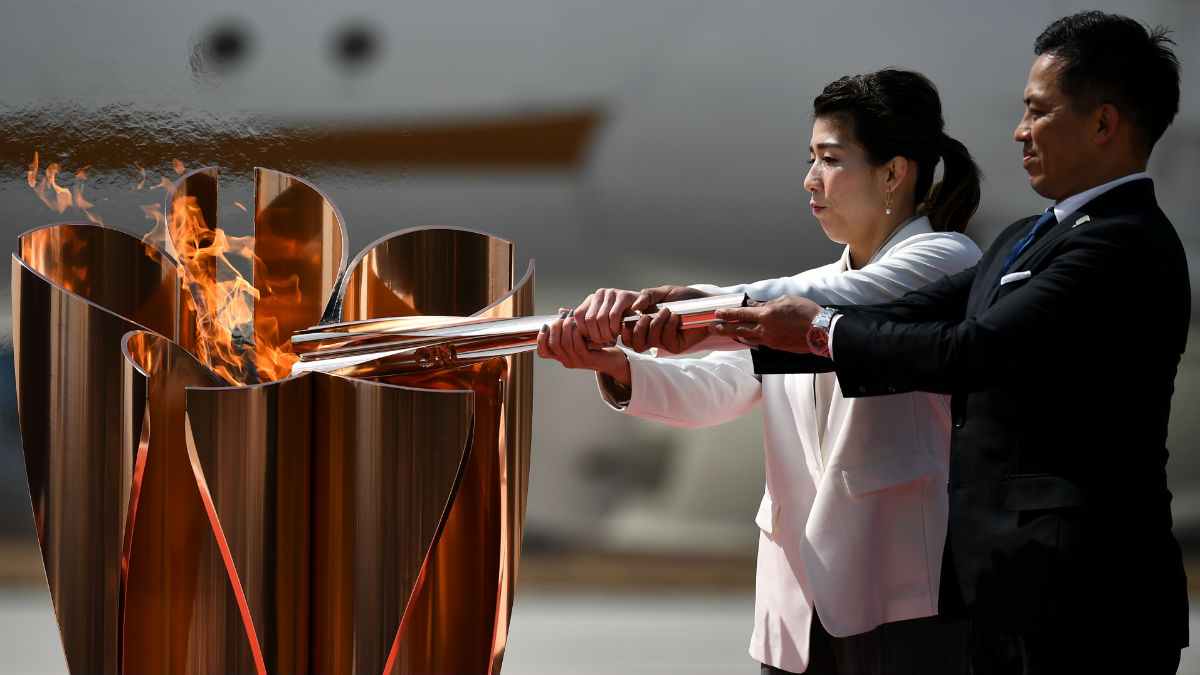 Dos medallistas olímpicos japoneses prenden la llama en Tokio 2020. (AFP)