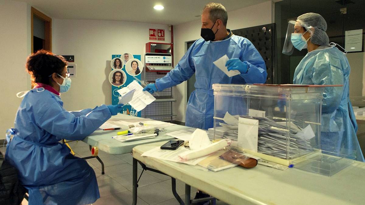 Miembros de una mesa electoral de El Masnou realizan el recuento de votos protegidos con trajes EPI (Foto: EFE).