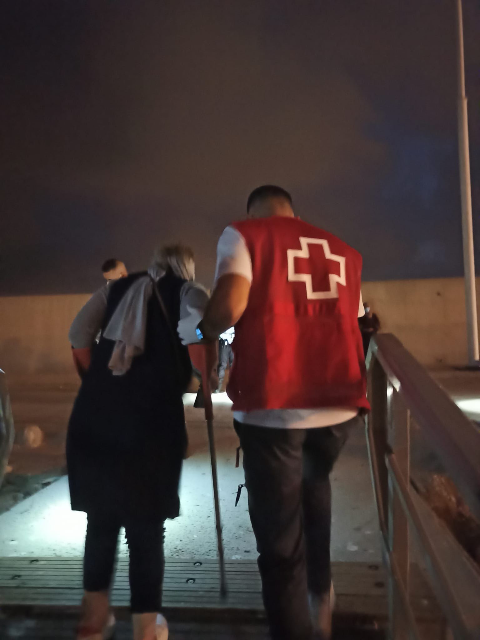 Una inmigrante es atendida por un miembro de Cruz Roja.