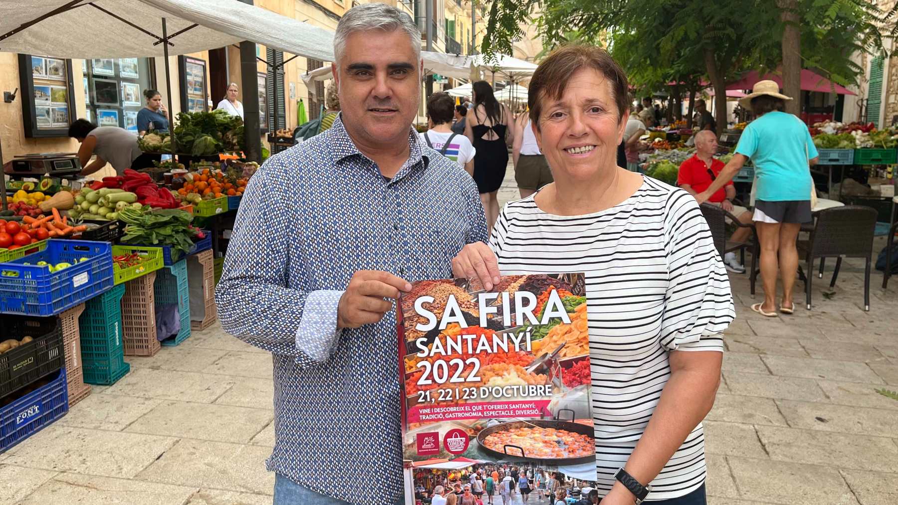 El regidor Antoni Matas y la alcaldesa Maria Pons mostrando el cartel de ‘Sa Fira’ de Santanyí 2022.