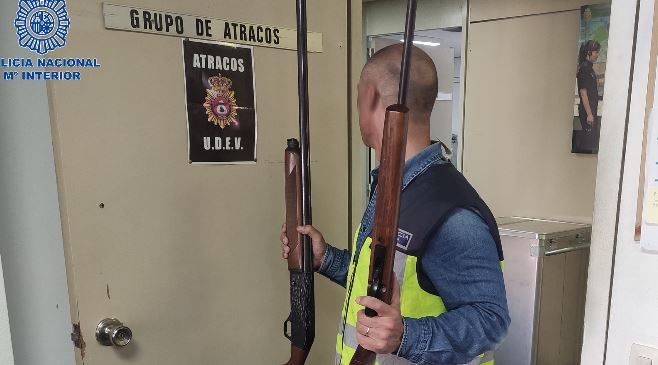 Un agente de la Policía Nacional en Palma sostiene algunas armas intervenidas al detenido. POLICÍA NACIONAL