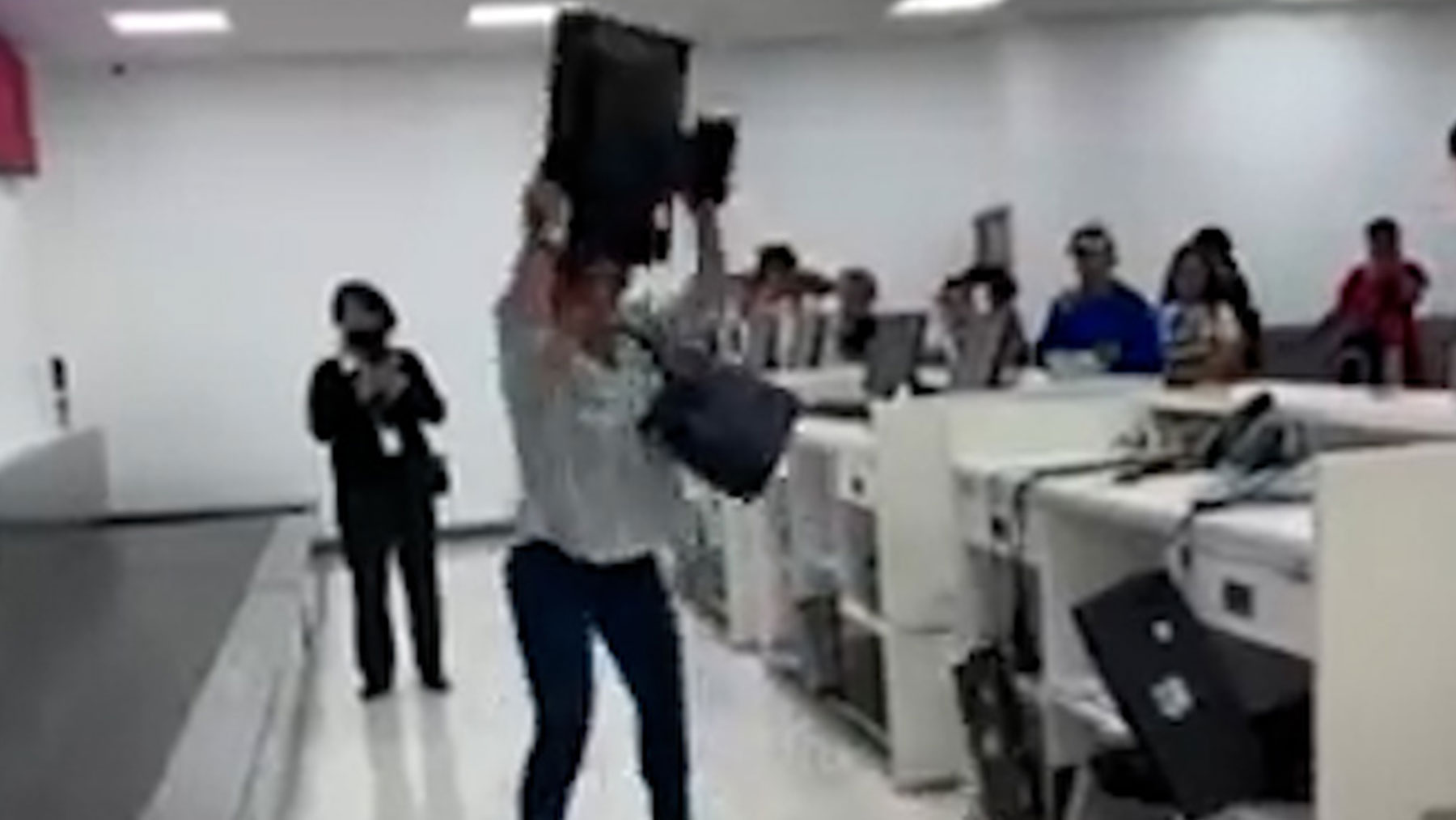 Mujer rompiendo un mostrador del aeropuerto de Ciudad de México