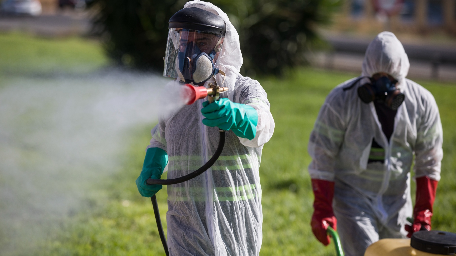 Dos trabajadores fumigan contra los mosquitos causantes del virus del Nilo en Coria del Río, Sevilla (EUROPA PRESS).