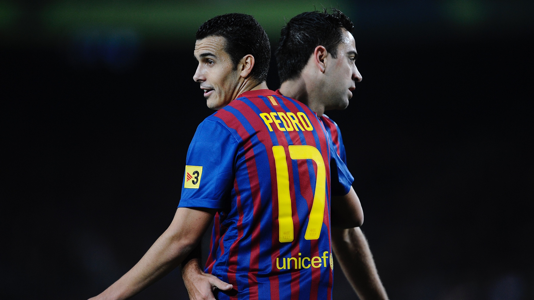 Pedro Rodríguez y Xavi Hernández, durante un partido del Barça en 2011. (Getty)