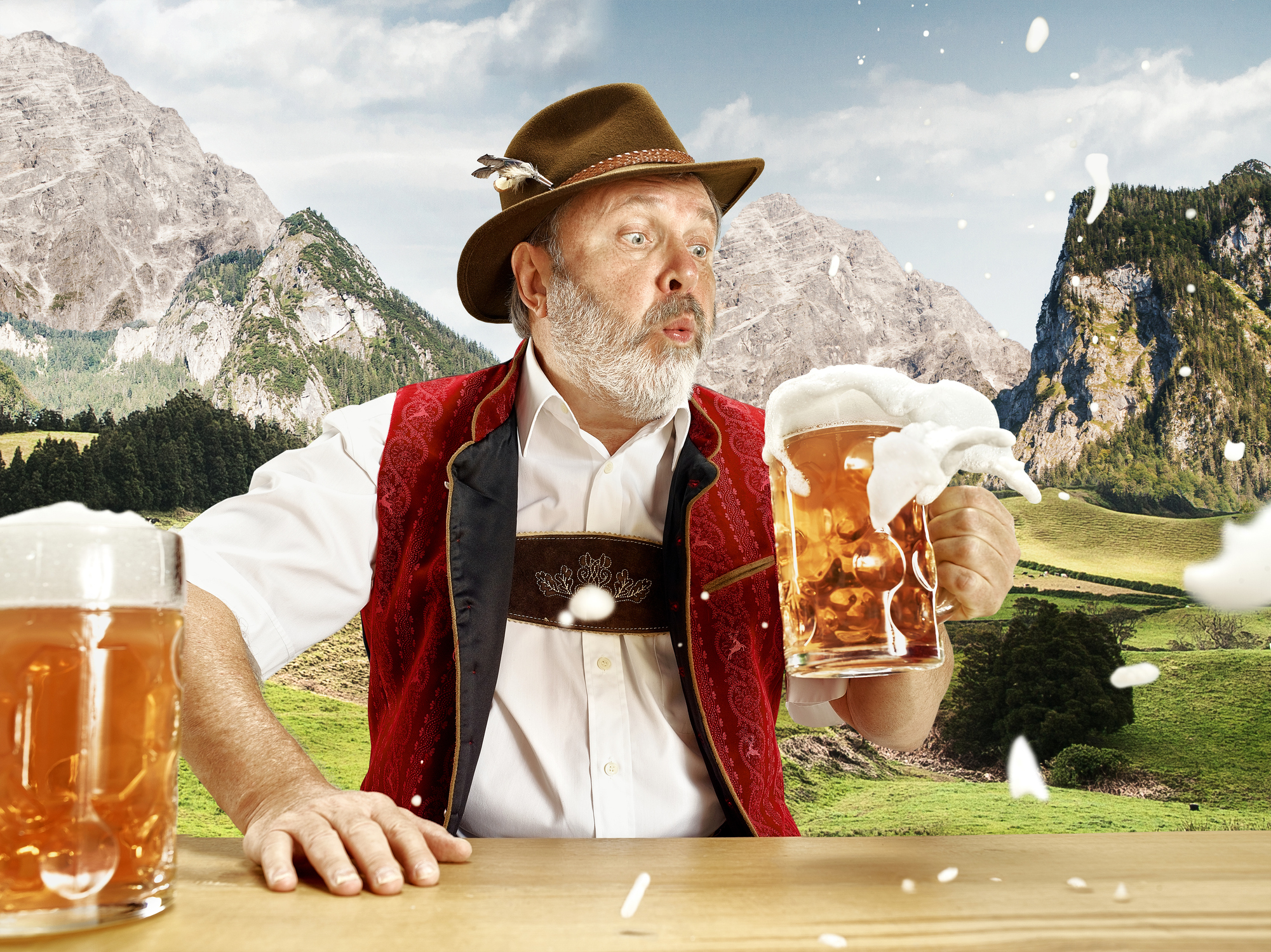 Germany, Bavaria, Upper Bavaria, man with beer dressed in traditional Austrian or Bavarian costume