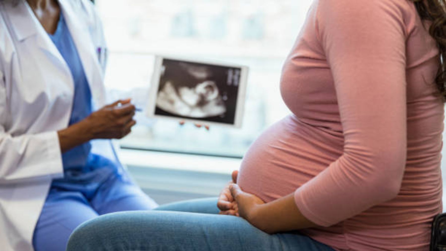 Mujer embarazada a la que se le muestra una ecografía.