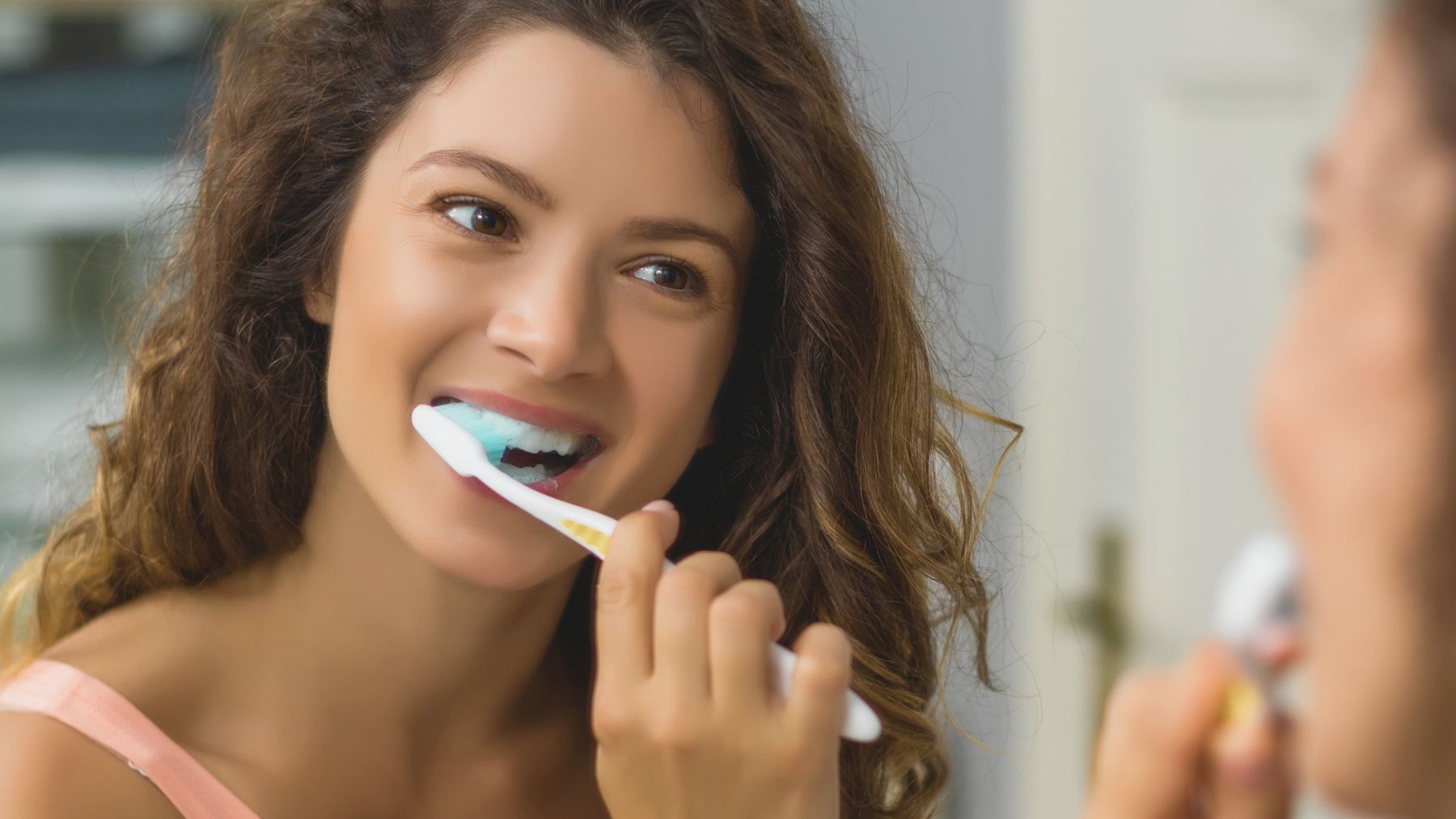 Una joven cepillándose los dientes.