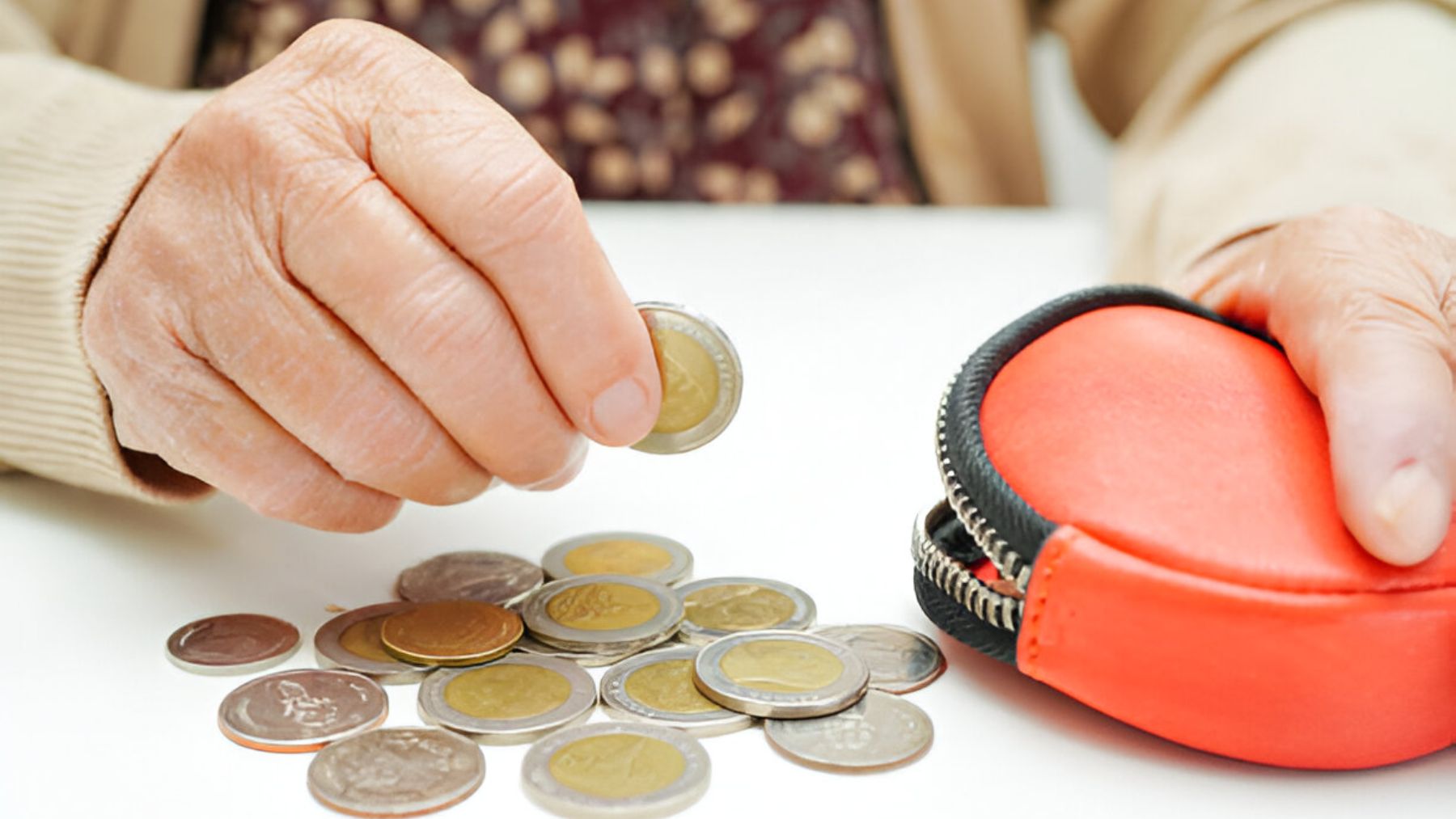 Mujer mayor con monedero y monedas.