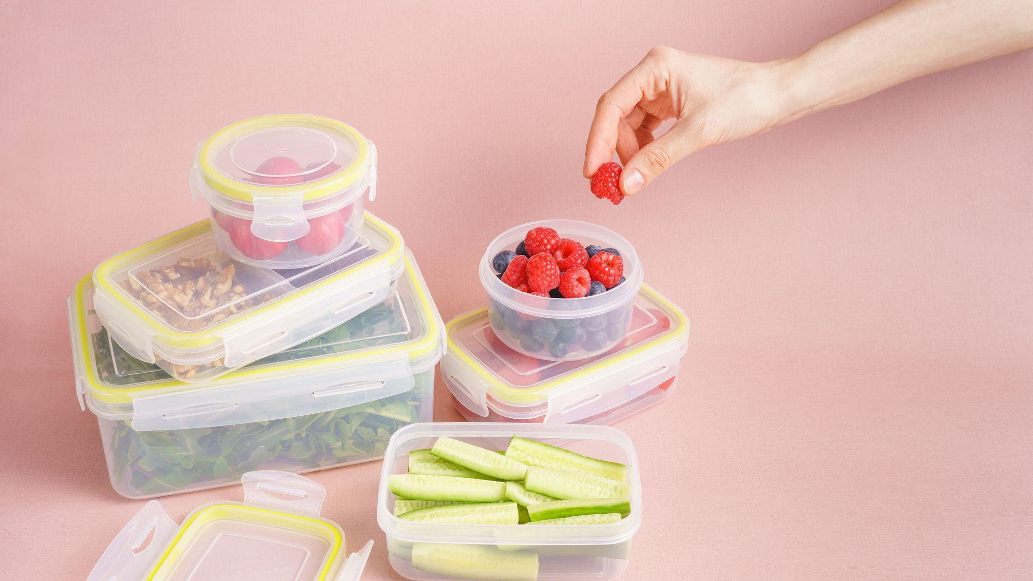 Reusable plastic containers with vegetables and berries