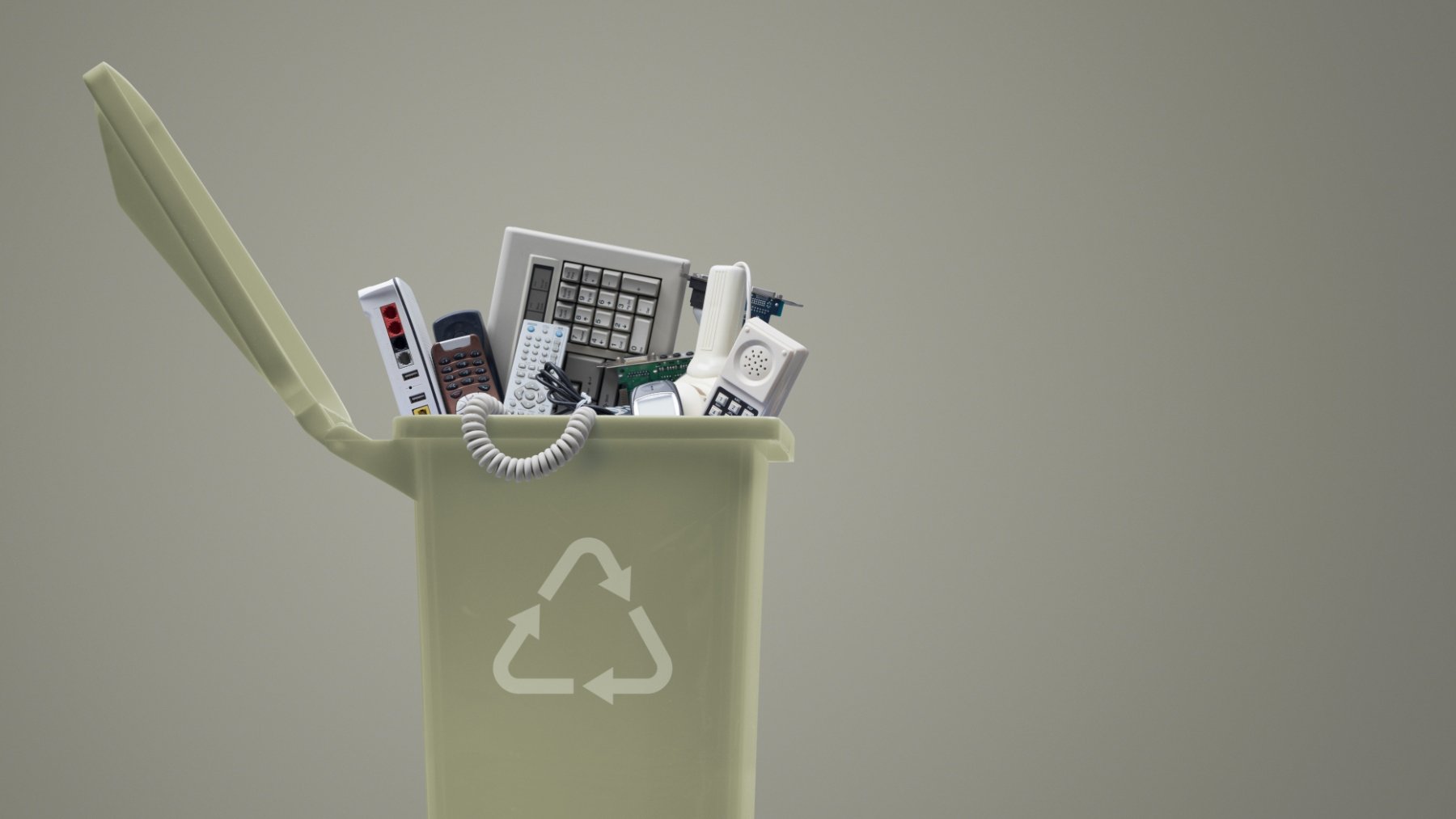 Waste bin full of electronics, e-waste and recycling concept