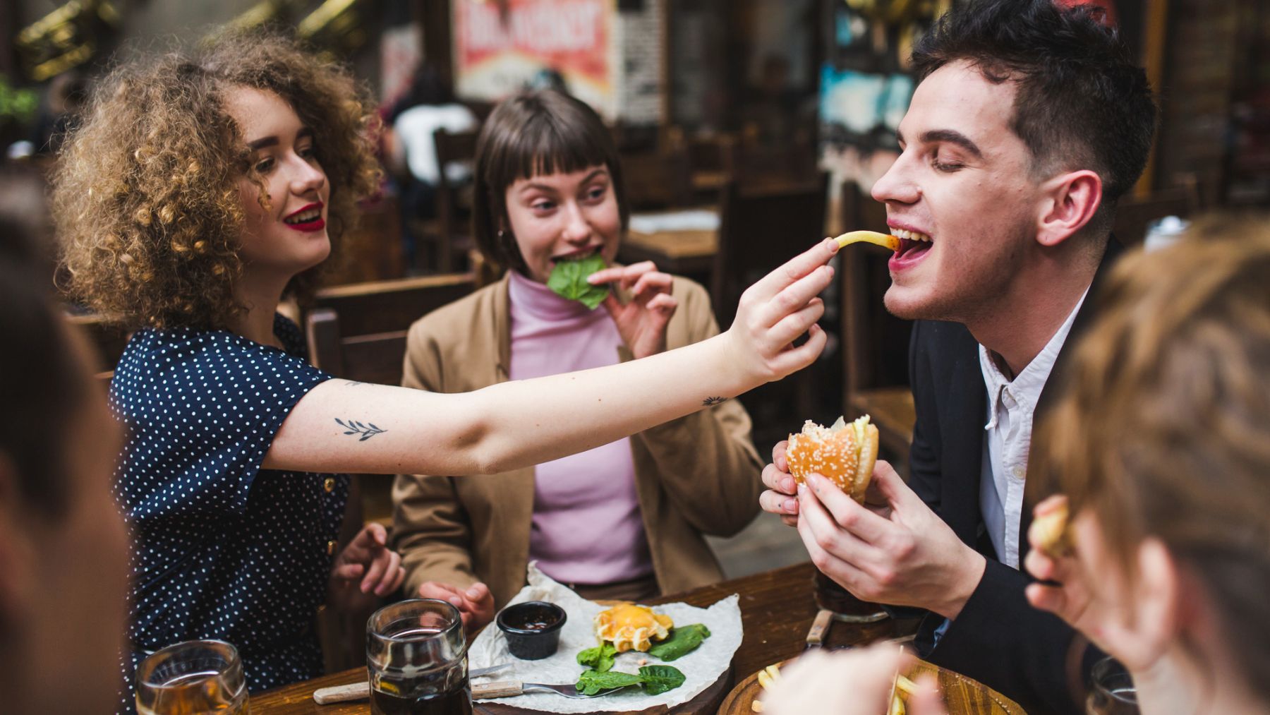 Amigos comiendo en un bar. Foto: Freepik