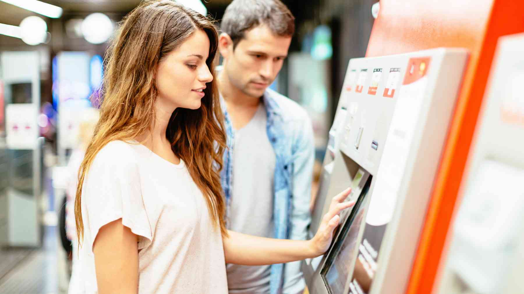 Dos jóvenes en la máquina del metro.