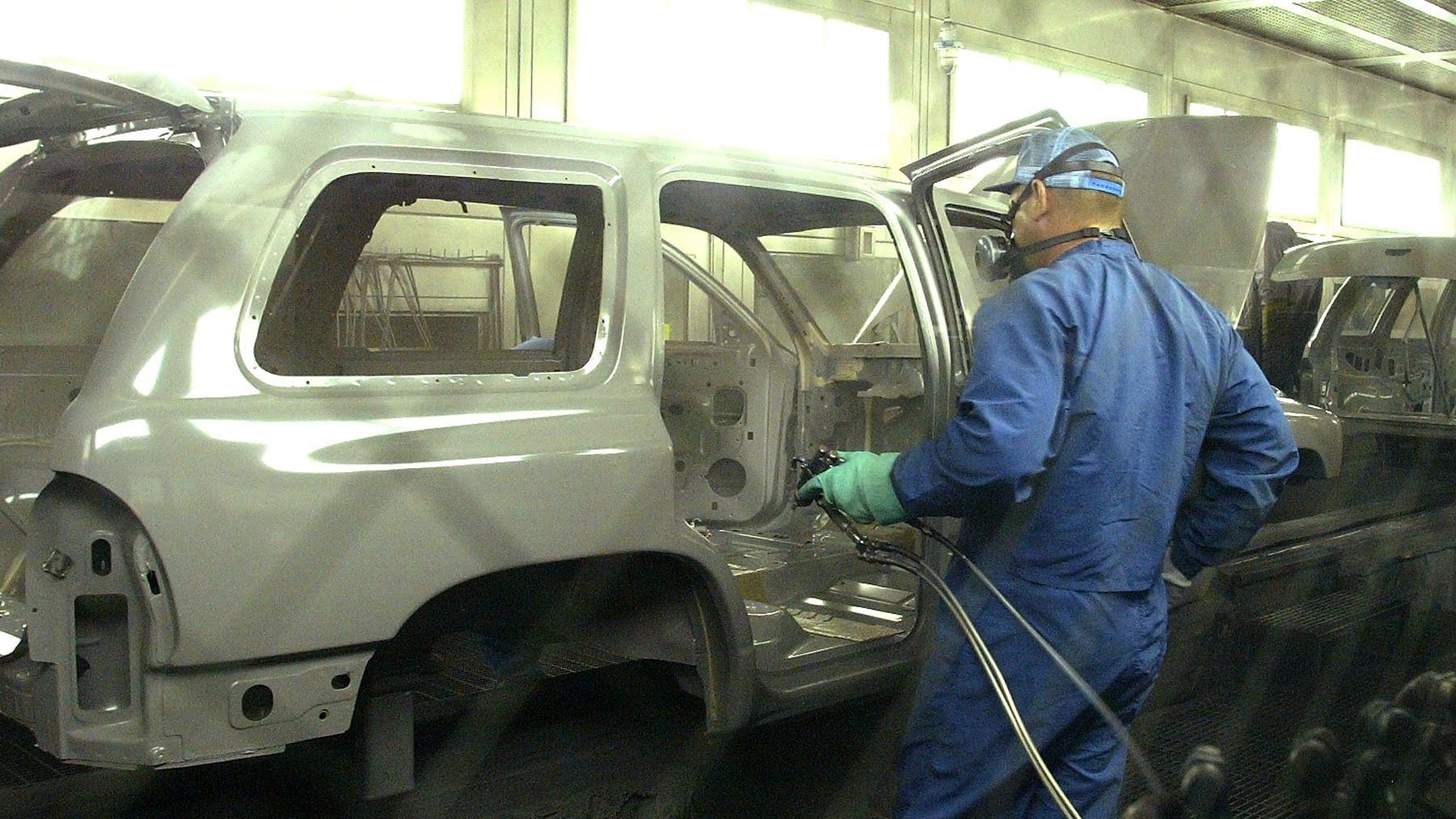 Trabajador pintando un coche 2