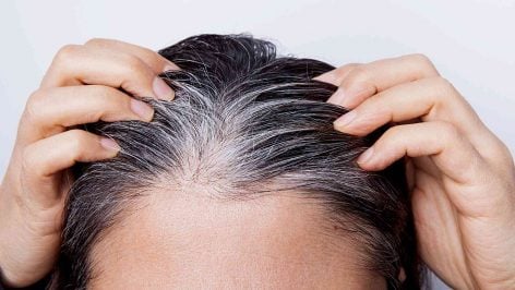 Una mujer con el cabello canoso.