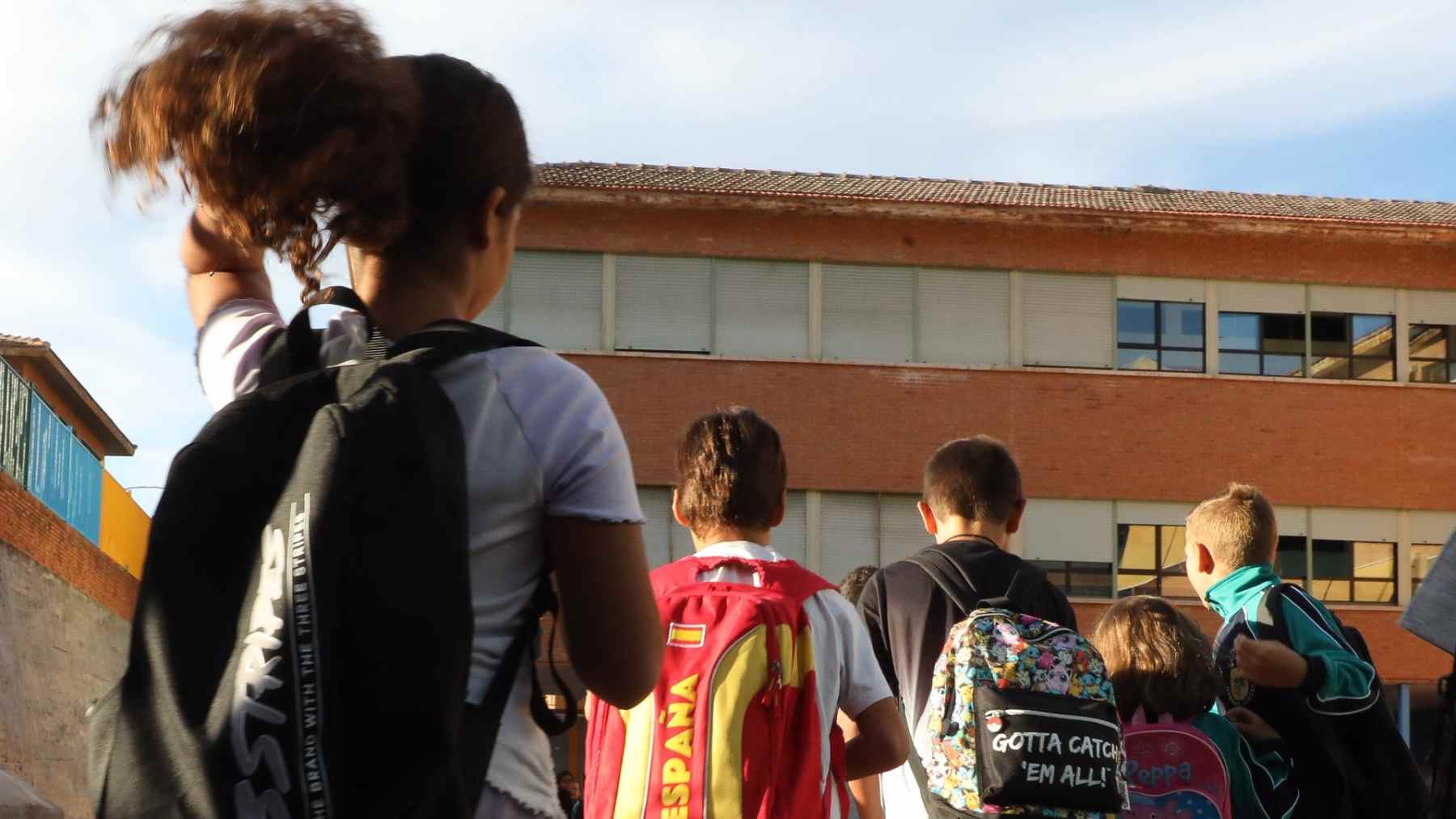 Varios niños a su llegada a un colegio.