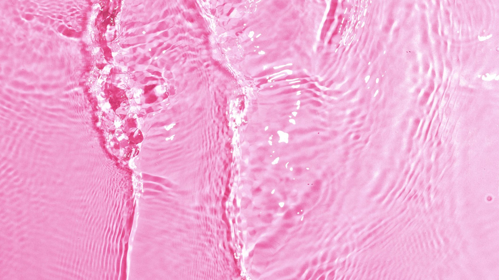 texture of splashing clean water on pink background