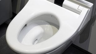 Cubrir el asiento en un baño público