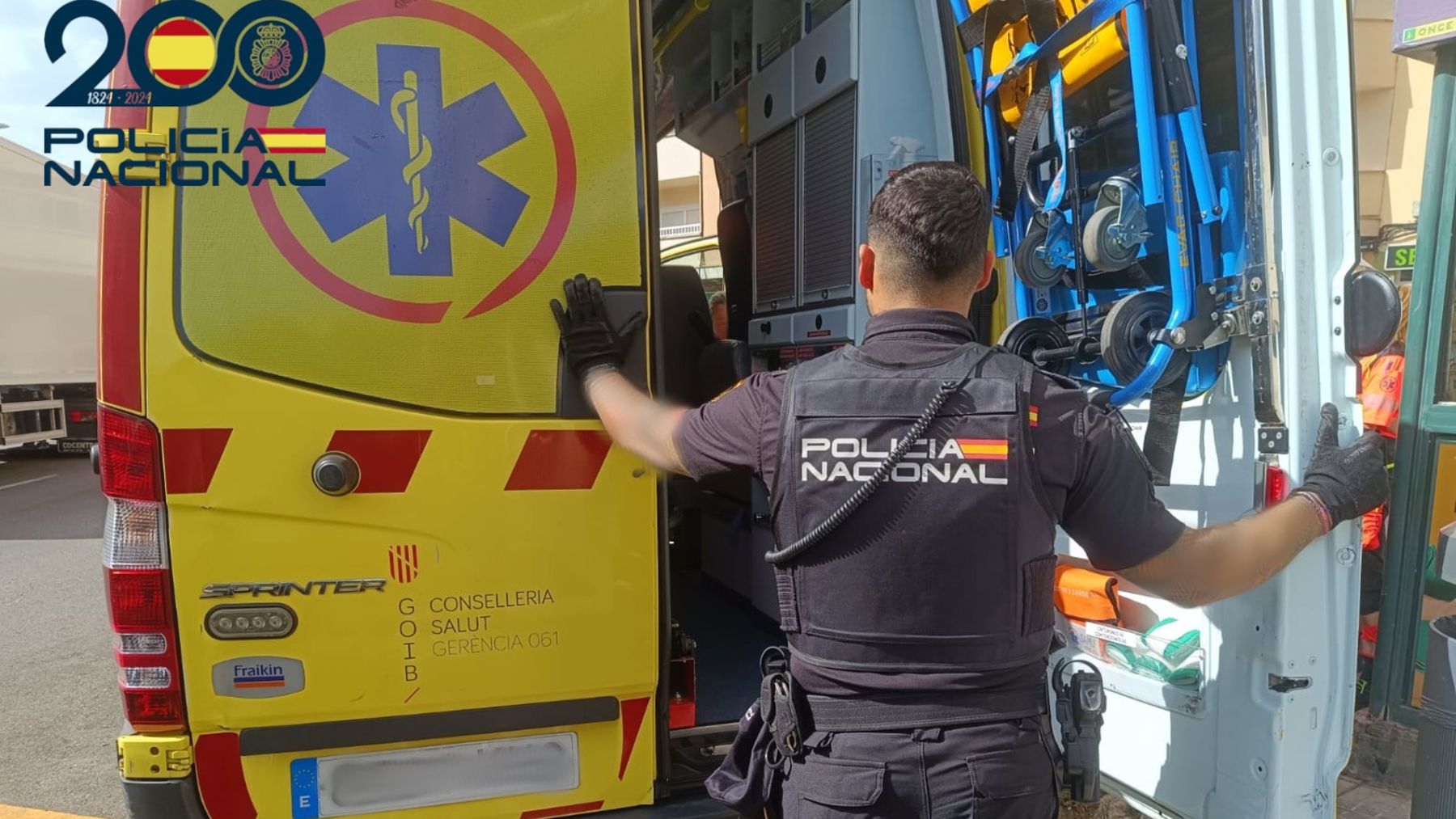 Un agente junto a la ambulancia.