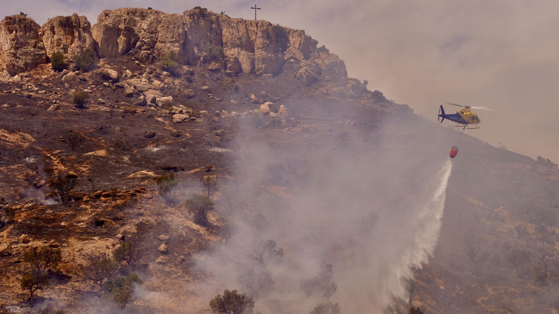 Medios aéreos actuando en un incendio en la zona de Monte Coronado, en Málaga. El cambio climático es uno de los factores que agravan este tipo de fenómenos extremos. (Foto: EUROPA PRESS).
