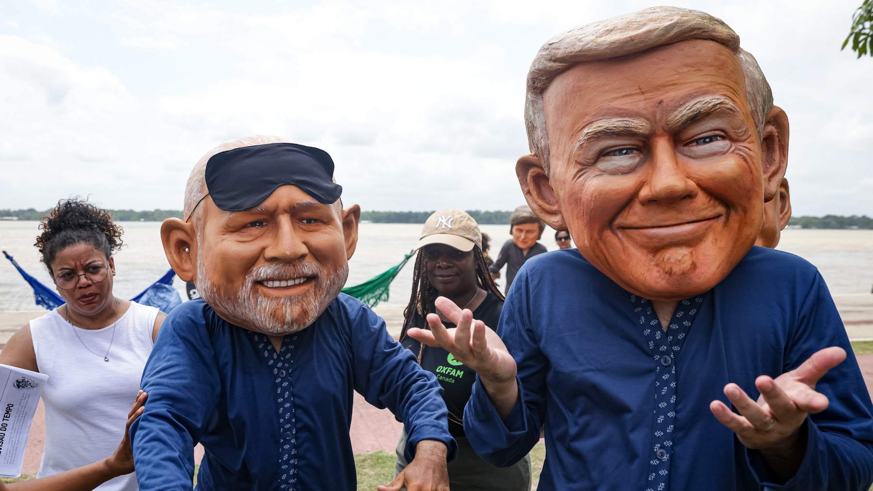 Activistas de Oxfam con máscaras del presidente brasileño Lula da Silva (izquierda) y del presidente estadounidense Donald Trump. (Foto: Allison Sales/dpa).