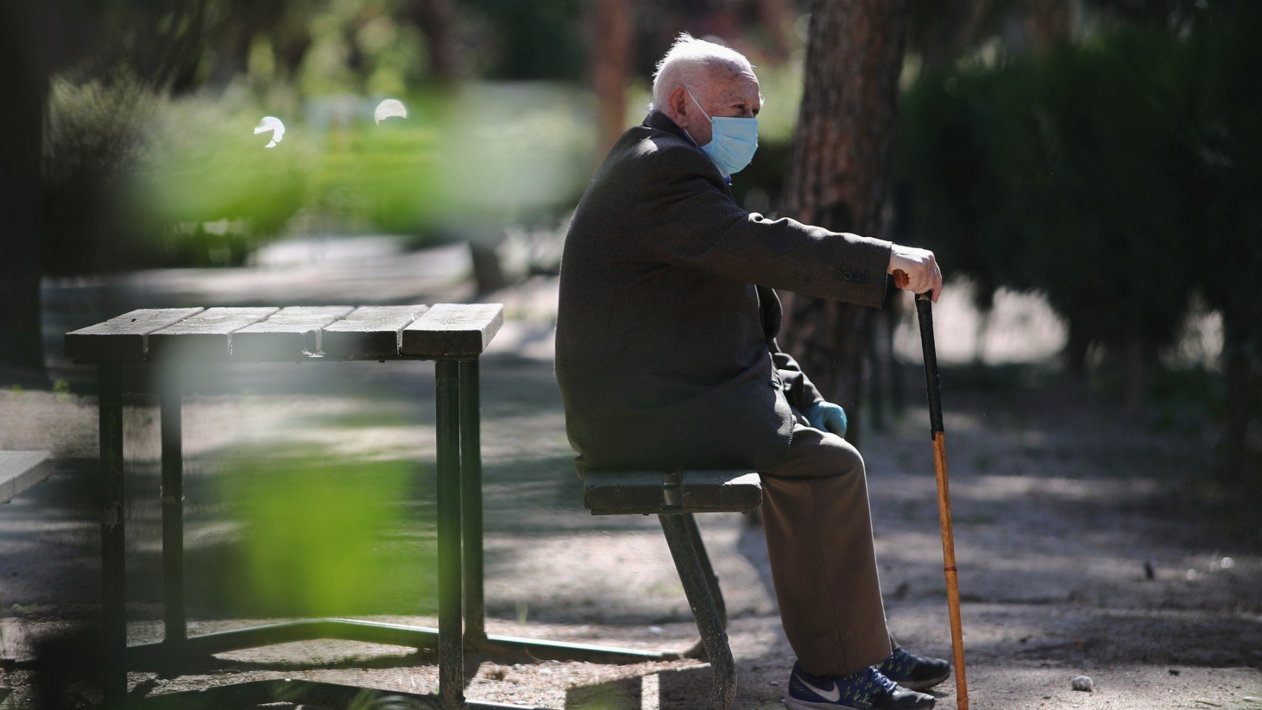 Una persona mayor con mascarilla en una residencia.