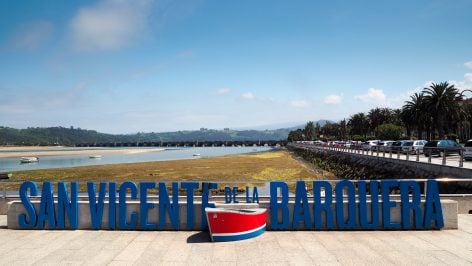 San Vicente de la Barquera sign and waterfront view in Cantabria, Spain