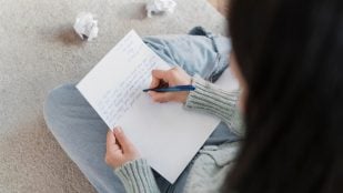 Joven mujer escribe una carta. Foto: Freepik
