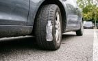 Botella en la rueda del coche (Imagen creada con IA).