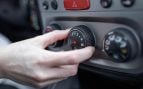 Mano encendiendo el sistema de aire acondicionado del coche. Foto: Freepik - @stefamerpik