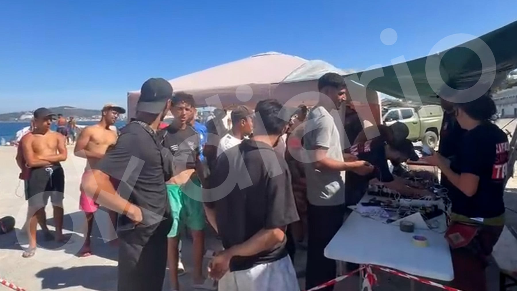 Una ONG alemana instala un puesto en la playa del Trampolín en Ceuta para regalar móviles y cargadores a los invasores