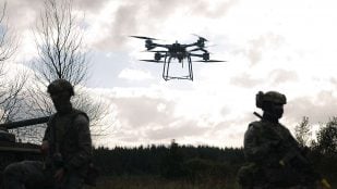 Un dron Malloy en vuelo sobre dos comandos del 48 Commando en Spadeadam, durante el ensayo de lanzamiento del dron Malloy