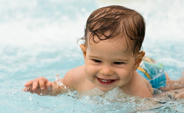 Smiling baby in the swimming pool