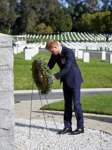 El pr&iacute;ncipe Harry depositando un adorno floral en el Cementerio Nacional de Los &Aacute;ngeles./Gtres