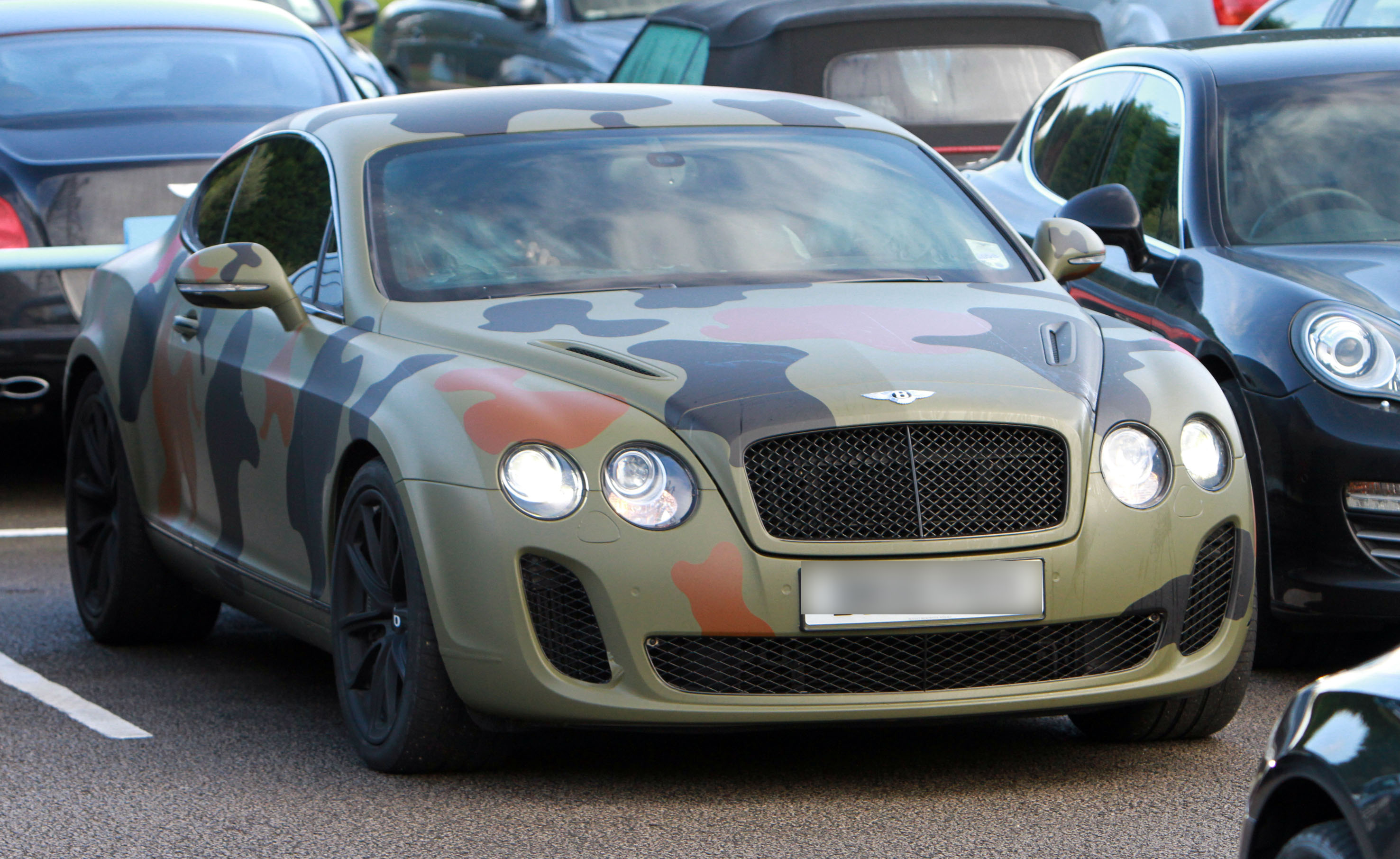 Mario Balotelli with his camouflage car leaving Manchester City training ground