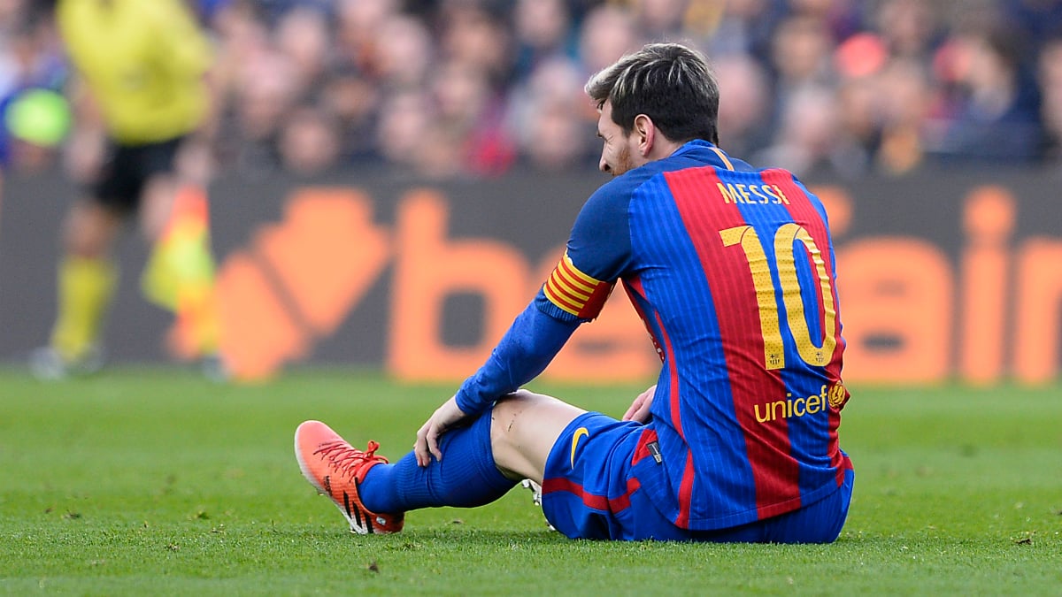 Messi en suelo durante el último Clásico. (AFP)