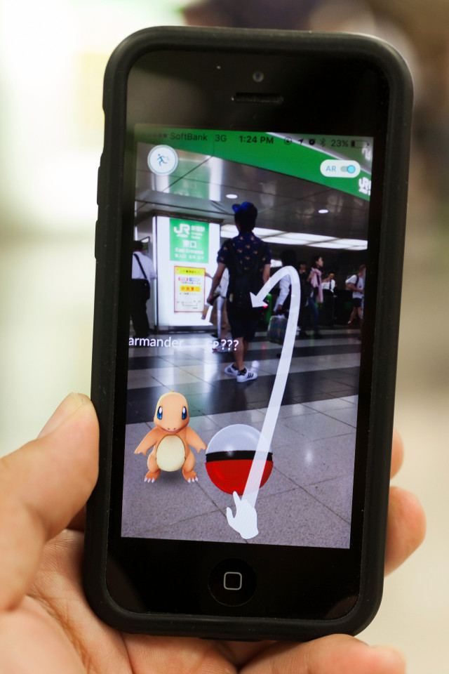 Fans try out Pokemon Go in Tokyo's Shinjuku district on July 22, 2016, Tokyo, Japan. The Pokemon Go app finally arrived in the land of the Pokemon on Friday 22, July two weeks after its launch in the United States. The release of the app in Japan had been rumoured for the past few days after the leak of details of a partnership deal with McDonalds Japan to create Pokemon Gyms in its 3,000 locations. Nintendo's market value has almost doubled since the app created by Niantic first launched in America. Ref: SPL1322964 220716 Picture by: Aflo / Splash News Splash News and Pictures Los Angeles: 310-821-2666 New York: 212-619-2666 London: 870-934-2666 photodesk@splashnews.com